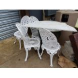 A MARBLE TOP PUB TABLE WITH BRITANNIA SUPPORTS AND FOUR VICTORIAN STYLE GARDEN CHAIRS. Dia.60cms.