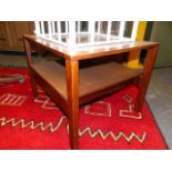 A MID CENTURY TEAK TELEPHONE TABLE, A NEST OF TWO TABLES AND A TEAK COFFEE TABLE. (4)
