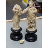 A PAIR OF DIEPPE IVORY FIGURES OF A MAN IN 17th.C.DRESS REACHING OUT TO THE JUG CARRIED BY THE LADY,