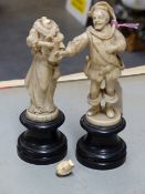 A PAIR OF DIEPPE IVORY FIGURES OF A MAN IN 17th.C.DRESS REACHING OUT TO THE JUG CARRIED BY THE LADY,