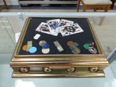 A GILT METAL MOUNTED PIETRA DURA GAMES BOX, THE BLACK GROUND LID INLAID WITH FOUR KING CARDS AND