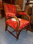 A RED VELVET UPHOLSTERED OAK GOTHIC REVIVAL SHOW FRAME ARMCHAIR, THE TAPERING FRONT LEGS FLUTED