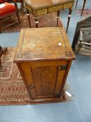 AN ARTS AND CRAFTS OAK AND INLAID BEDSIDE CABINET