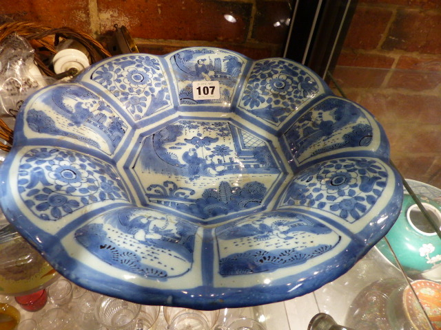 AN ANTIQUE GERMAN DELFT BLUE AND WHITE DISH WITH NINE FLORAL AND CHINOISERIE PANELS ENCLOSING THE