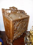 A CARVED FRUITWOOD MAGAZINE BOX, THE LID CARVED WITH WARRIOR HEAD ROUDEL, THE FRONT WITH APPLIED