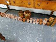 A COLLECTION OF ANTIQUE AND LATER TERRACOTTA FLOWER POTS.