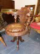 AN ANTIQUE OAK SWIVEL CAPTAINS CHAIR, THE BACK CARVED WITH FOLIAGE, THE CIRCULAR DROP IN CUSHIONED