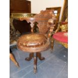 AN ANTIQUE OAK SWIVEL CAPTAINS CHAIR, THE BACK CARVED WITH FOLIAGE, THE CIRCULAR DROP IN CUSHIONED