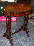 A ROSEWOOD WORK TABLE, THE EBONISED EDGED SHAPED OVAL LID OPENING ONTO COMPARTMENTS, THE TWIN COLUMN