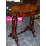 A ROSEWOOD WORK TABLE, THE EBONISED EDGED SHAPED OVAL LID OPENING ONTO COMPARTMENTS, THE TWIN COLUMN