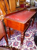 A VICTORIAN MAHOGANY WRITING TABLE WITH THREE DRAWERS OVER TURNED AND REEDED LEGS ON BRASS