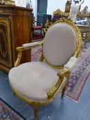 A PAIR OF FRENCH CARVED GILTWOOD LOUIS XVI STYLE SALON ARMCHAIRS WITH OVAL BACKS AND SHAPED SEATS