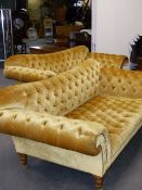 A PAIR OF BESPOKE QUALITY OCHRE BUTTONED VELVET SCROLL ARM SOFAS STANDING ON TURNED LEGS