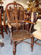 A 19th.C YEW WOOD AND ELM WINDSOR ARMCHAIR WITH CRINOLINE STRETCHER.