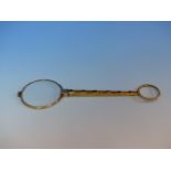 A HAND HELD YELLOW GOLD MAGNIFYING GLASS SET WITH OLD CUT DIAMONDS AND SAPPHIRES. LENGTH 13cms,