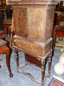 AN 18th.C.AND LATER OAK AND BURRWOOD CABINET ON STAND THE TWO DOOR UPPER SECTION ENCLOSING FITTED