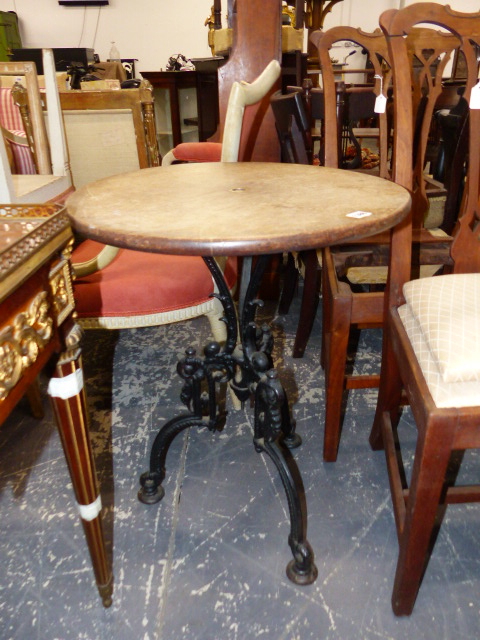 AN ANTIQUE CAST IRON BASE CIRCULAR TABLE, CIRCULAR OAK TOP ABOVE GOTHIC REVIVAL STYLE TRIFID BASE.