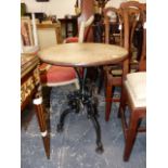 AN ANTIQUE CAST IRON BASE CIRCULAR TABLE, CIRCULAR OAK TOP ABOVE GOTHIC REVIVAL STYLE TRIFID BASE.