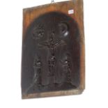 AN OAK PANEL CARVED IN RELIEF WITH CHRIST CROUCHED BELOW THE SUN AND MOON WHILE TWO SAINTLY LADIES
