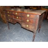 AN EARLY 19th.C. MAHOGANY WRITING OR DRESSING TABLE WITH CROSS BANDED TOP OVER SIX DRAWERS AND