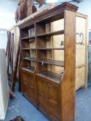 AN ELM DOUBLE BOOKCASE, THE TWO BANKS OF FOUR OPEN SHELVES ABOVE PAIRS OF PANELLED DOORS. 169 x 38 x