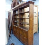 AN ELM DOUBLE BOOKCASE, THE TWO BANKS OF FOUR OPEN SHELVES ABOVE PAIRS OF PANELLED DOORS. 169 x 38 x