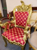 A GILTWOOD ARMCHAIR WITH SPREAD EAGLE CRESTED UPHOLSTERED BACK, A FOLIATE CARVED APRON TOP TO THE