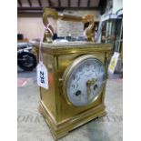 A BRASS CASED CLOCK THE FRENCH MOVEMENT STRIKING ON A COILED ROD BELOW THE PLATFORM ESCAPEMENT,