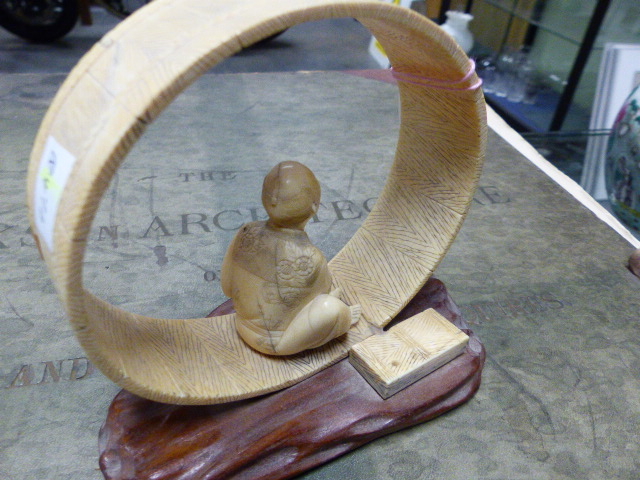 A JAPANESE IVORY FIGURE SEATED WITHIN AN UNFINISHED COOPERED TUB ON IT'S SIDE. H.12cms. - Image 2 of 10