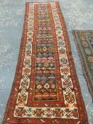 AN ANTIQUE PERSIAN TRIBAL RUNNER. 325 x 94cms.