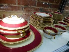 AN AYNSLEY PART DINNER SERVICE, EACH PIECE WITH GILT BEADING ENCLOSING CLARET AND CREAM BANDS. 55