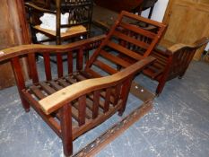 A PAIR OF ANTIQUE TEAK RECLINING ARMCHAIRS IN THE ARTS AND CRAFTS MANNER. (2)