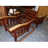 A PAIR OF ANTIQUE TEAK RECLINING ARMCHAIRS IN THE ARTS AND CRAFTS MANNER. (2)