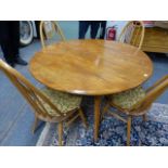 AN ERCOL PALE ELM DROP LEAF DINING TABLE AND A SET OF FOUR HIGH HOOP BACK DINING CHAIRS. (5)