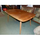 AN ERCOL PALE ELM EXTENDING DINING TABLE WITH TWO LEAVES TOGETHER WITH A SET OF EIGHT ERCOL STICK