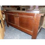 AN 18th.C.AND LATER OAK PANEL COFFER WITH CARVED FRIEZE ON STILE SUPPORTS. 118 x 50 x H.61cms.