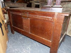 AN 18th.C.AND LATER OAK PANEL COFFER WITH CARVED FRIEZE ON STILE SUPPORTS. 118 x 50 x H.61cms.