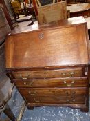 A MAHOGANY BUREAU WITH FIVE GRADUATED LONG DRAWERS OVER BRACKET FEET. 89 x 68 x 41cms.