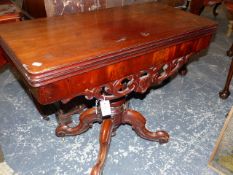 A MAHOGANY RECTANGULAR SWIVEL TOP TEA TABLE, THE SCROLL APRON ABOVE BALUSTER COLUMN AND FOUR LEGS ON