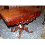 A MAHOGANY RECTANGULAR SWIVEL TOP TEA TABLE, THE SCROLL APRON ABOVE BALUSTER COLUMN AND FOUR LEGS ON