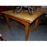 AN OCHRE YELLOW PAINTED PINE DRAW LEAF TABLE ON TAPERING SQUARE SECTIONED LEGS JOINED BY TWO ROUND