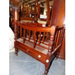 A MAHOGANY CANTERBURY WITH FOUR DIVISIONS AND CENTRAL PIERCED HANDHOLD ON RING TURNED TAPERED LEGS