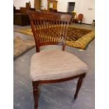 A SET OF SEVEN MAHOGANY DINING CHAIRS TO INCLUDE ONE WITH ARMS, THE BROAD TOP RAILS ABOVE SLATTED