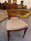 A SET OF SEVEN MAHOGANY DINING CHAIRS TO INCLUDE ONE WITH ARMS, THE BROAD TOP RAILS ABOVE SLATTED