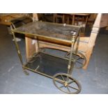 A RETRO BRASS FRAMED DRINKS TROLLEY.