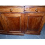 A VICTORIAN PINE AND FRUITWOOD BREAKFRONT CABINET WITH FOUR PANEL DOORS OVER THREE DRAWERS AND
