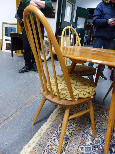AN ERCOL PALE ELM DROP LEAF DINING TABLE AND A SET OF FOUR HIGH HOOP BACK DINING CHAIRS. (5) - Image 2 of 7