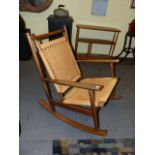 A MID CENTURY ROCKING CHAIR IN THE MANNER OF HANSWEGNER.