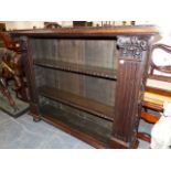 A VICTORIAN OAK OPEN FRONT SMALL BOOKCASE WITH CARVED PANEL SIDES. 121 x 31 x 98cms.