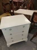 A PAIR OF PAINTED PINE BEDSIDE CHESTS OF TWO SHORT AND THREE LONG DRAWERS WITH RING HANDLES